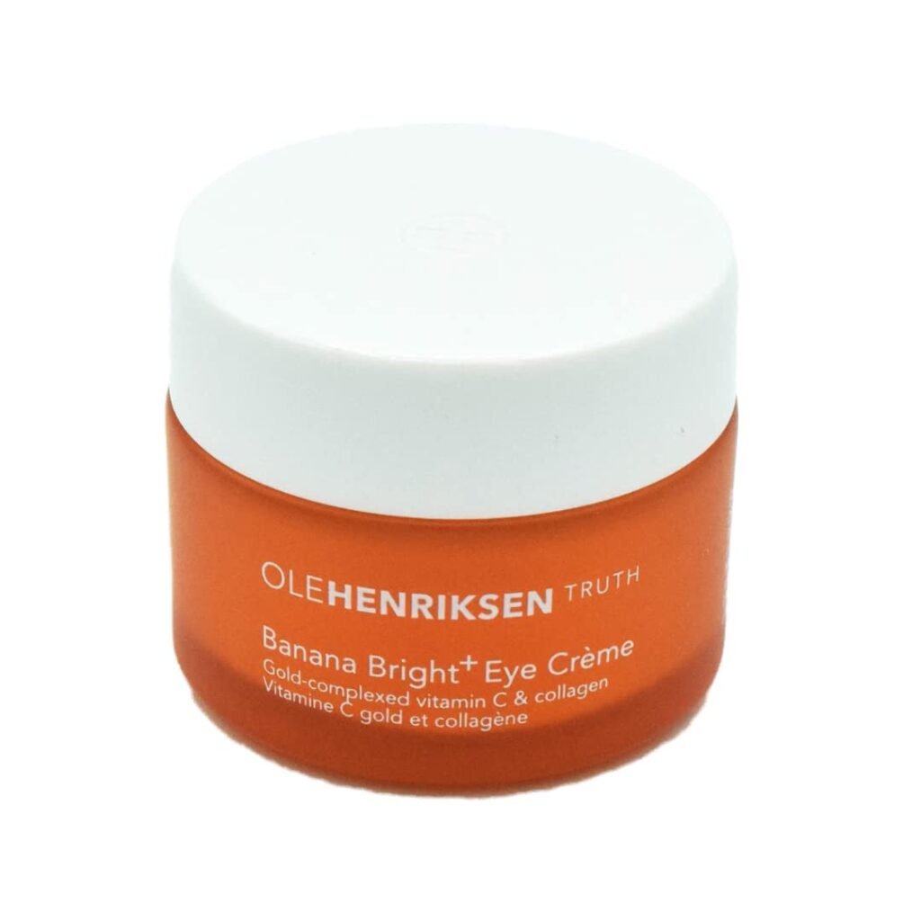 An orange jar of OLEHENRIKSEN Truth Banana Bright+ Eye Crème with a white lid, formulated with gold-complexed vitamin C and collagen to target under eye circles causes.