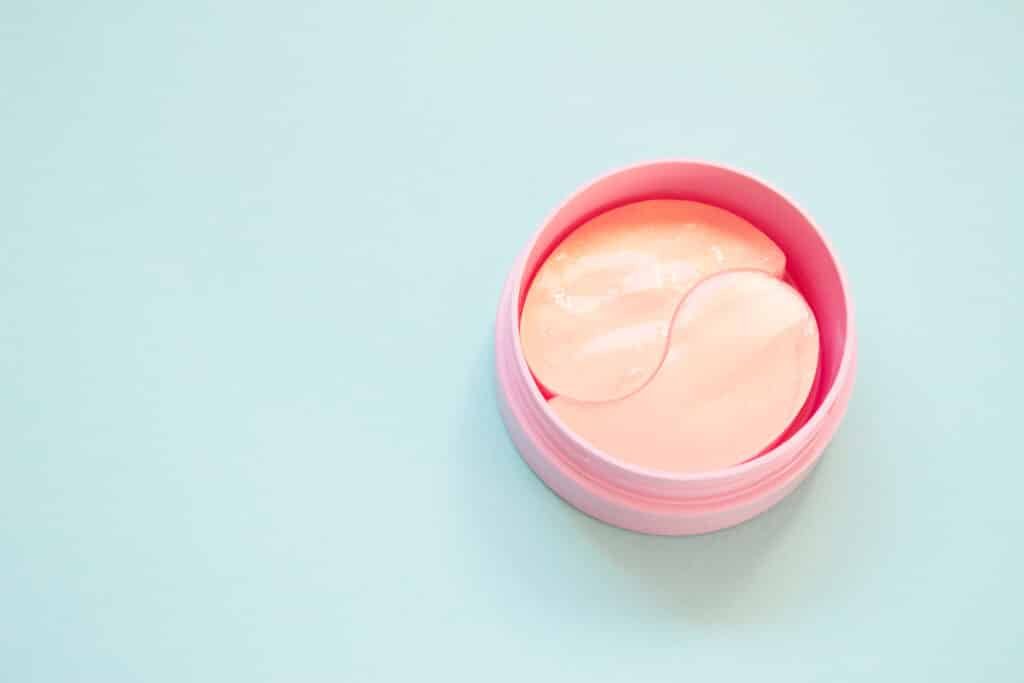 Vegan Eye Mask: 5 Proven Picks That Actually Work 2026 golden pink hydrogel patches for eyes on blue background. cosmetology, self care, health care.