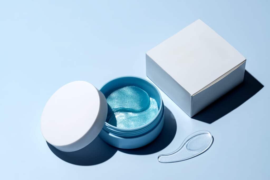 Vegan Eye Mask: 5 Proven Picks That Actually Work 2026 hydrogel cosmetic eye patches for skin care on blue pastel background. product for skin lifting, anti aging wrinkles. under eyes patches in a blue container. cosmetics mockup